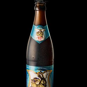 Close-up of a water bottle with condensation against a dark background.